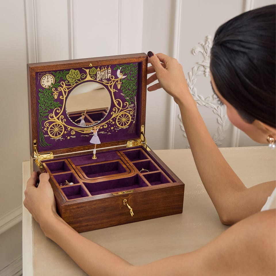 Styled image of the Wolf Cinderella Ballet Musical Jewellery Box 190017 displayed on a dresser, presented as a decorative jewellery storage piece. Its walnut wood veneer finish and fairytale-inspired design suit both everyday use and gifting.