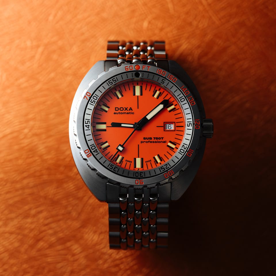 DOXA SUB 750T Automatic 45mm Watch 825.10.351.10 - lifestyle shot on a wooden background