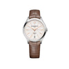 Front-facing view of the Baume & Mercier Clifton Baumatic M0A10831 ladies' watch, featuring an off-white grained dial with crosshair pattern, black minute track, gilded trapezoid-shaped indexes, Arabic numeral at 12 o'clock, alpha-shaped hands, satin-finished stainless steel case, and an interchangeable brown alligator leather strap.