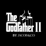 White 'The Godfather II' movie-style title graphic with puppet strings and hands above the text, plus 'BY JACOB&CO' below, on a solid black background.
