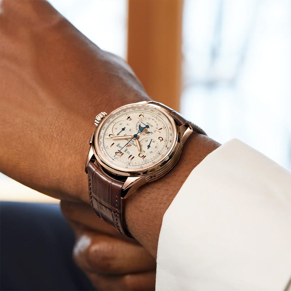 Breitling Premier B25 Datora 42mm Watch RB2510371G1P1 is shown worn on the wrist, highlighting the proportions of its 42mm case and curved alligator strap. This complete calendar chronograph is powered by the COSC-certified Caliber B25 with a complication-rich moon-phase display.