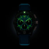 Breitling Avenger B01 Chronograph 42mm Watch SB0146101L1X1 shows the luminous properties of its dial markers and hands in low light. The military-inspired turquoise dial remains legible against the illuminated ceramic case in dark conditions.