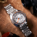 DOXA SUB 300T Searambler Automatic 42.50mm Watch 840.10.021.10 - lifestyle shot with white dial, orange accents and rice detail steel bracelet