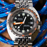 DOXA SUB 300T Sharkhunter Automatic 42.50mm Watch 840.10.101.10 - lifestyle show showing the orange accented dial