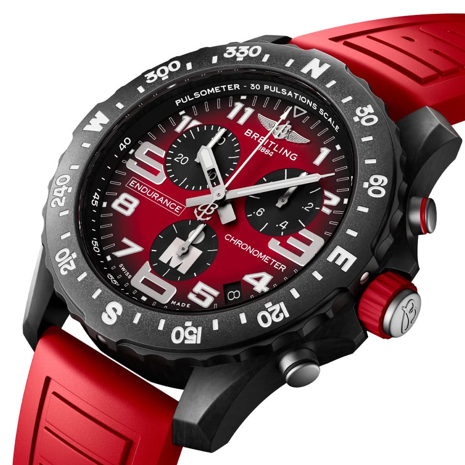 Breitling Endurance Pro Quartz Chronograph 44mm Watch X823109A1K1S1 shows the sapphire crystal and textured Breitlight® finish from an angled perspective. The branded IRONMAN® rubber strap curves into the 44mm case.