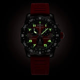 Breitling Endurance Pro Quartz Chronograph 44mm Watch X823109A1K1S1 shows the luminous properties of its dial markers and hands in low light. The red IRONMAN® dial remains legible against the illuminated Breitlight® case in dark conditions.