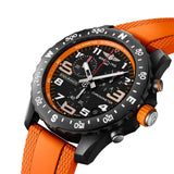 Breitling Endurance Pro Quartz Chronograph 44mm Watch X82310A51B1S2 shows the sapphire crystal and textured Breitlight® finish from an angled perspective. The orange rubber strap curves into the 44mm case for an athletic, everyday-wear profile.