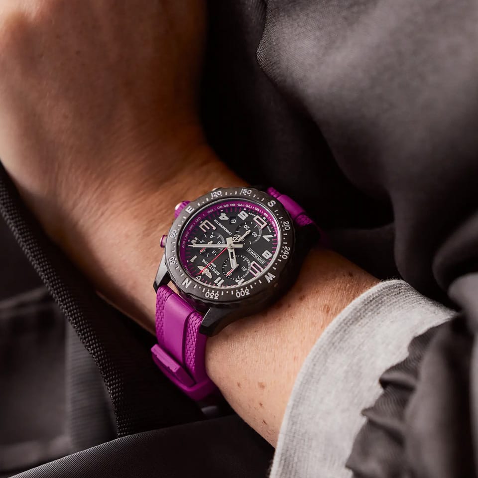 Breitling Endurance Pro Quartz Chronograph 38mm Watch X83310F61B1S1 is shown worn on the wrist, highlighting the proportions of its 38mm case and purple rubber strap. This chronograph is powered by the COSC-certified SuperQuartz™ Caliber 83, roughly ten times more accurate than standard quartz.