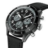 Breitling Super AVI B04 Chronograph GMT 46mm Watch SB04451A1B1X1 shows the bidirectional ratcheted bezel and cambered sapphire crystal from an angled perspective. The titanium pushers and crown contrast against the black ceramic case.